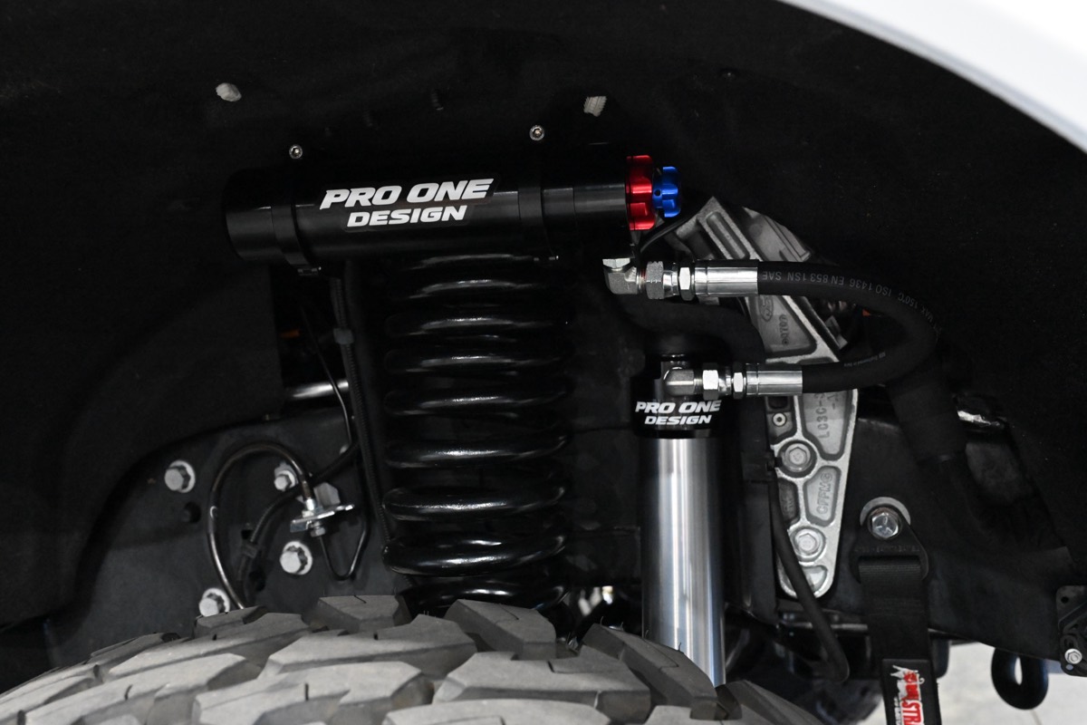 Pro One Design coilover and remote reservoir installed in a truck wheel well